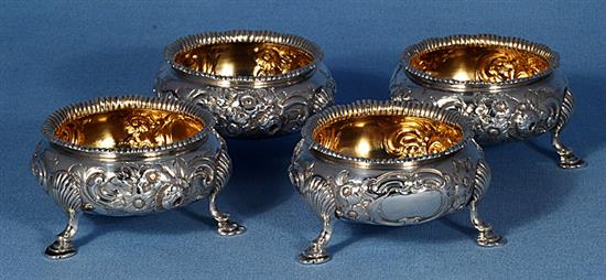 A set of four Victorian embossed silver table salts, by Roberts & Briggs, height 47mm, weight 12.8oz/401grms.